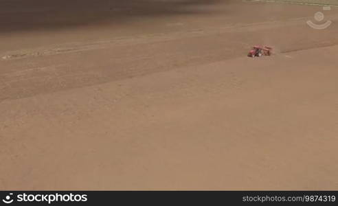 Aerial of tractor on harvest field