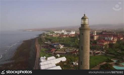 Aerial panorama of tourist town and resort areas on Gran Canaria coast, Maspalomas Lighthouse in the foreground