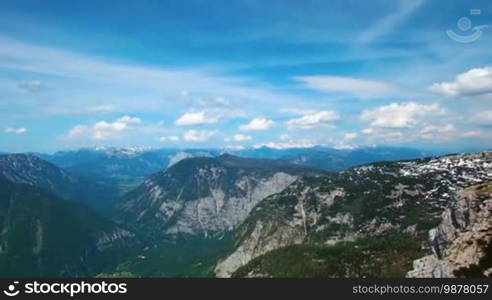 Aerial panoramic view of mountains with pine woods forest. Sun flare in summer day in Austria, Obertraun