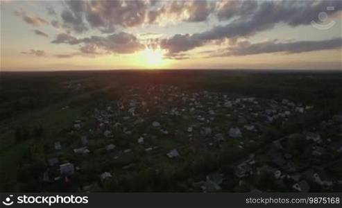 Aerial scene of countryside at sunset. Russian dacha community