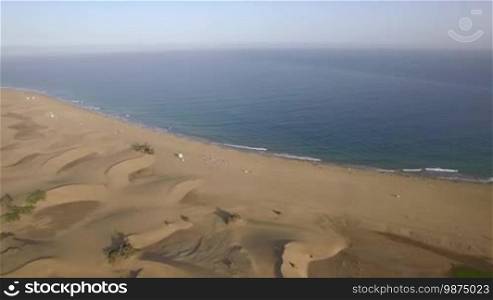 Aerial scene of Gran Canaria, Canary Islands. Beach with people, sand dunes and clear blue ocean