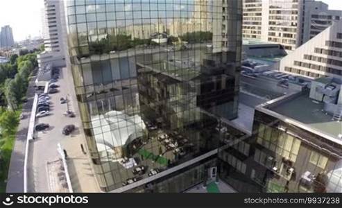 Aerial shot of modern building with mirror glasses and Moscow view reflecting there