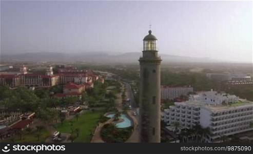 Aerial shot of resort town on the coast of Gran Canaria with Maspalomas Lighthouse in foreground