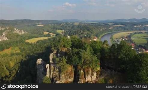Aerial view of a magnificent panoramic view of Bastai in Germany next to the river on a sunny day. In the background, beautiful scenic nature.