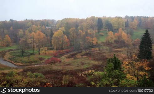 Aerial view of autumn forest and curving river in Toila, Estonia.