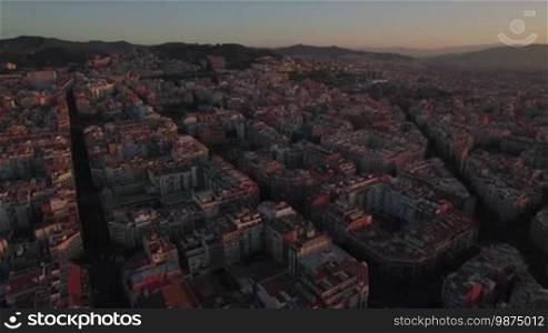 Aerial view of Barcelona at sunset. Cityscape with streets and houses, Spain