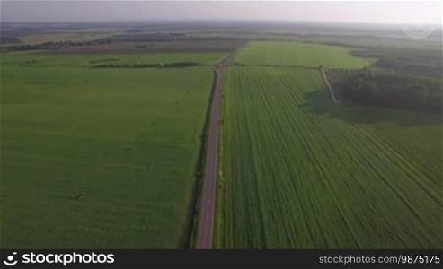 Aerial view of roads running through the vast green fields. Landscapes of Russia