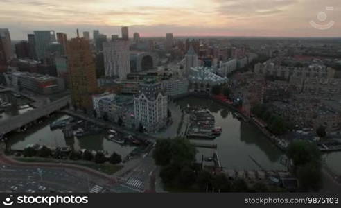 Aerial view of Rotterdam with its unique architecture and boats at anchor. Cityscape at sunset, Netherlands