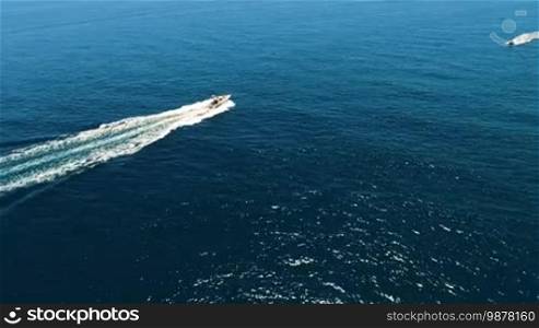 Aerial view of yachts swimming past each other in the open sea at high speed. Spain, Catalonia