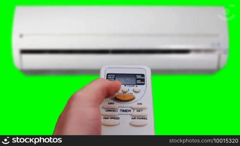 Air conditioner and remote control in hot summer weather, isolated on green screen