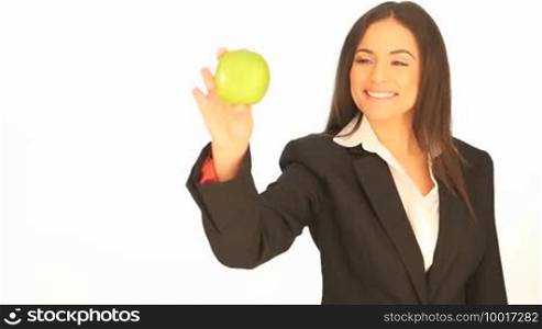 Attractive businesswoman with an apple in her hand which she is moving across the frame