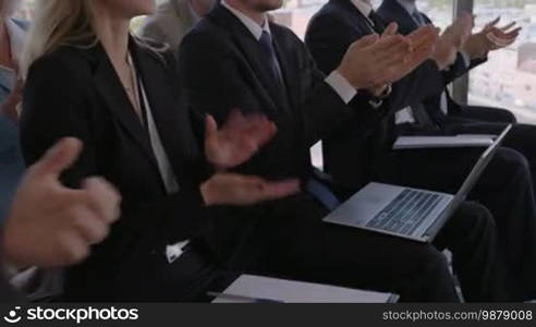 Audience applauding at a business seminar