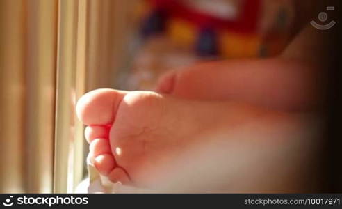 Baby's foot. Close-up. Sunlight.