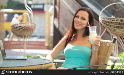 Beautiful Brunette drinking milkshake at Downtown Cafe