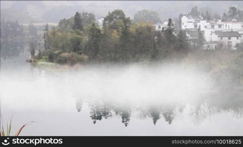 Beautiful old village in China, timelapse of fog crossing over river