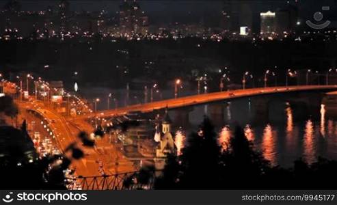 Beautiful view of a night city with illuminated bridges, Kiev, Ukraine