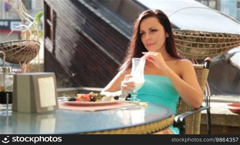Beautiful woman has dinner in the cafe