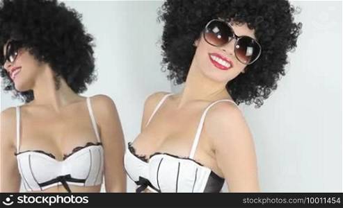 Beautiful woman in afro, sunglasses and lingerie