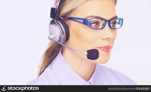 Beautiful young telesales lady wearing glasses and a headset