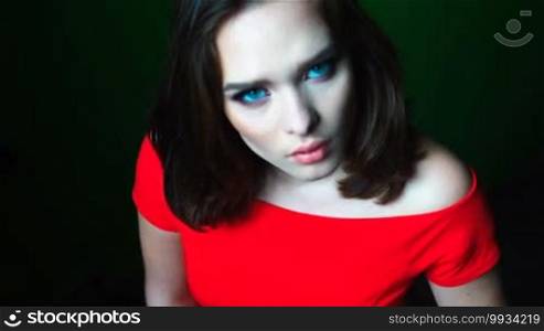 Beauty woman with mesmerizing eyes and red dress