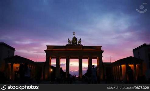 Berlin - Brandenburg Gate with tourists at sunset in time-lapse