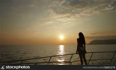 Bikini Female Silhouette on Yacht at Sunset