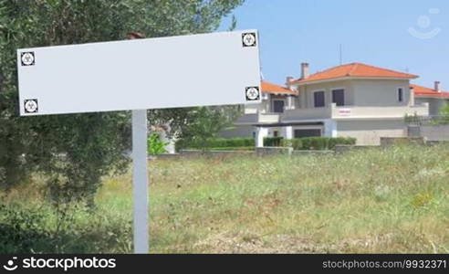 Blank signpost in neighborhood, house for sale in background. Real estate industries. Chroma key with tracking motion markers
