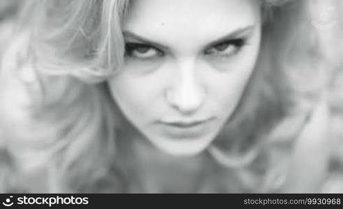 Blonde woman in the forest black and white portrait looking up