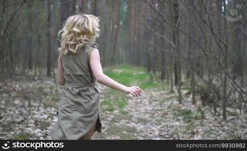 Blonde woman in the forest running