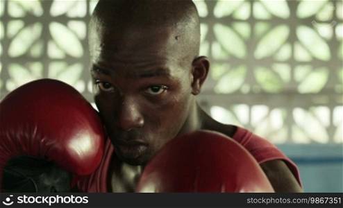 Boxing and people, young African American athlete exercising in boxing gym