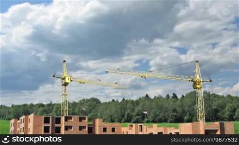 Building a big living house from scratch, real image on background of cloudy sky near forest, timelapse