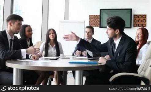 Business people applaud at meeting after presentation