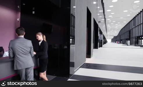 Business people filling in forms at reception front desk