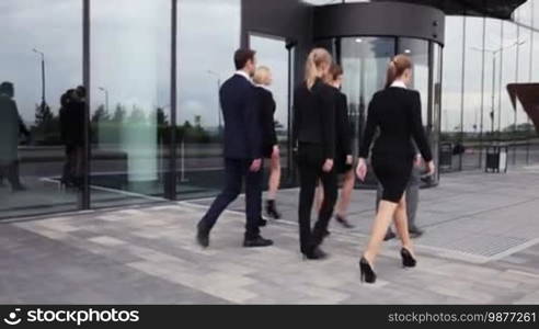 Business people team walking outdoors near office building