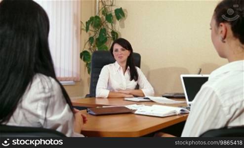 Business women are discussing in a meeting, focus on background