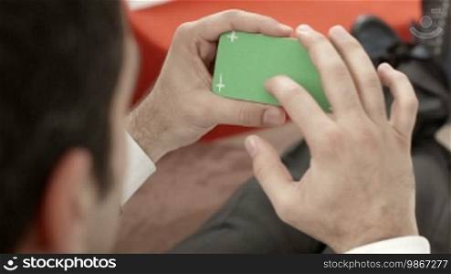 Businessman using smartphone with green screen for internet and email. Sequence
