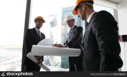 Businessmen and architects team in office planning construction project of skyscrapers