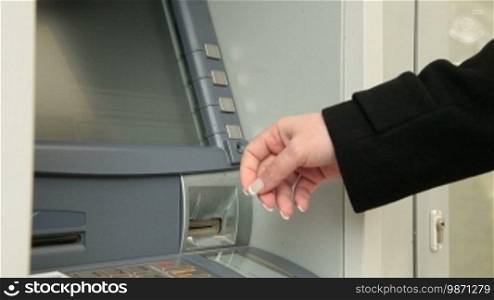 Businesswoman Withdrawing Money From ATM Machine
