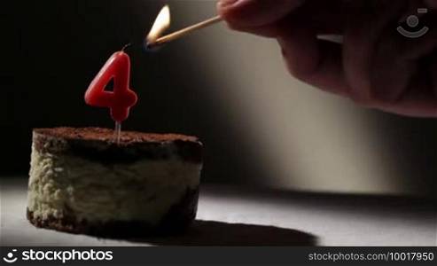 Candle four in tiramisu cake. Birthday vintage background.
