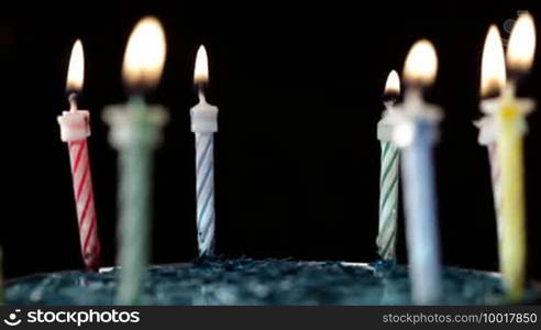 Candles rotation on black background.