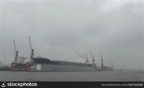 Cargo ship in Hamburg port. Fog.