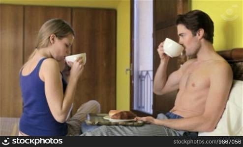 Caucasian woman serving breakfast to her boyfriend in bed. Sequence