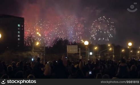 Celebration time in the city. People gathering in the street to watch night fireworks