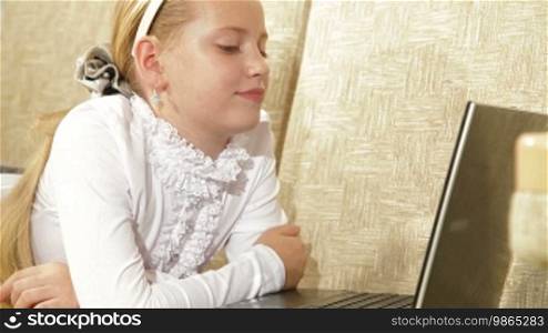 Child communicates with friends in a social network using a laptop