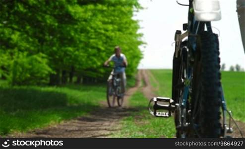 Child riding bike down a country lane