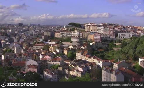 Cityscape (houses, buildings, skyscrapers) of Lisbon from above, the roofs of Lisbon. Blue sky with white clouds.