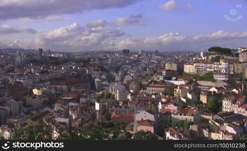 Cityscape (houses, buildings, skyscrapers) of Lisbon from above, the roofs of Lisbon. Blue sky with white clouds.