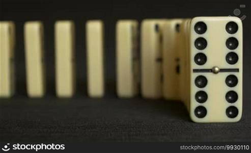 Close up frontal view of the domino effect in real time
