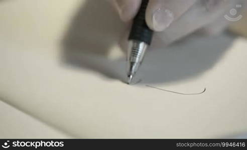 Close-up of hand drawing a cartoon woman with a black pen.