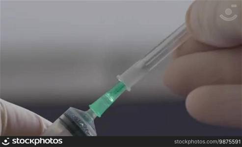 Close up of medical hand putting the cap on hypodermic needle